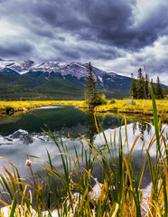 The cloudy sky is reflected in the lake