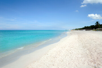 Remote tropical beach with fine white sand, clear turquoise blue water and few tourists in Varadero, Matanzas province, most famous beach resort in Cuba and one of the largest resorts in the Caribbean