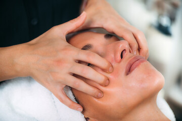 Obraz na płótnie Canvas Enjoying Ayurvedic Face Massage With Essential Oil in a Wellness Room