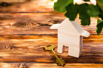 Wooden toy house and house keys close up