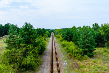 Fototapeta na wymiar Old railroad in forest on summer