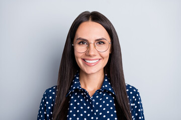 Close-up portrait of attractive cheerful businesslady wearing specs isolated over grey pastel color background