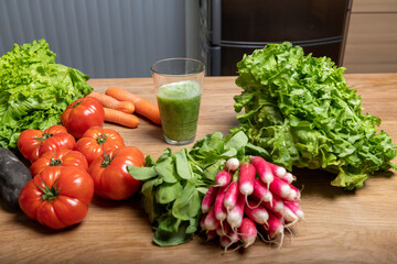 Vegan woman making vegetable juice for detox