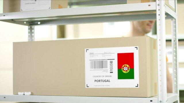 Warehouse worker puts a carton with goods from Portugal
