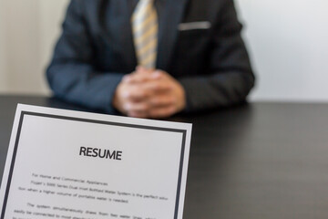 job interview in office, focus on resume writing tips, employer reviewing good cv of prepared...