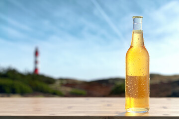 Dewy glass bottle with blank white label in back light.