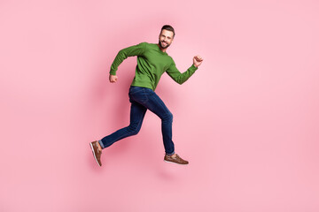 Fototapeta na wymiar Full length body size profile side view of attractive cheerful guy jumping running fast isolated over pink pastel color background