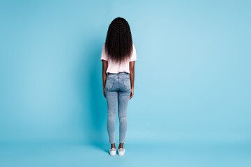 Full length rear behind view photo of pretty slim afro woman wear pink t-shirt jeans hands arms...