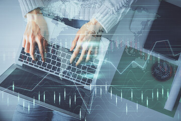 Multi exposure of woman hands working on computer and forex chart hologram drawing. Top View....