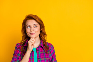 Portrait of adorable lady arm on chin look empty space wear magenta plaid isolated on yellow color background
