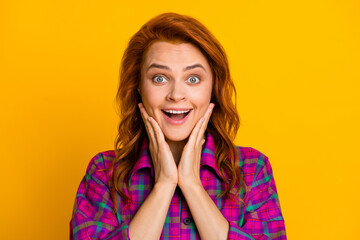 Portrait of attractive impressed person arms on cheeks open mouth wear violet plaid isolated on yellow color background