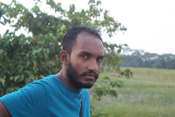 Portrait of handsome runner with beard in nature