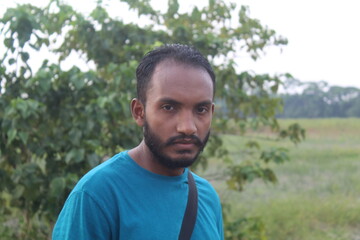 Portrait of handsome runner with beard in nature