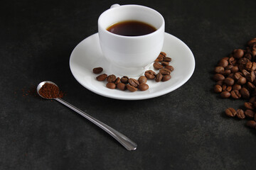 frothy coffee drink. Cappuccino or latte in a transparent glass on a dark background.