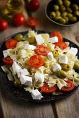 Pasta bows with feta and olives. Italian Cuisine.