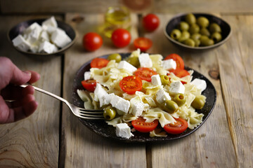 Pasta bows with feta and olives. Italian Cuisine.
