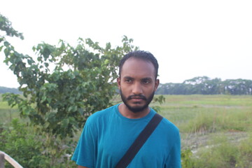 Portrait of handsome runner with beard in nature