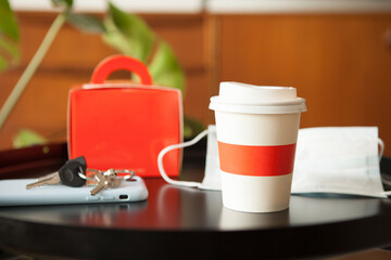 Take away food - box and cup of speciality coffee at home on the table. Food delivery service. Lifestyle photo, natural light, ordering online food concept.