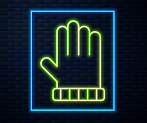 Glowing neon line Christmas mitten icon isolated on brick wall background. Vector.