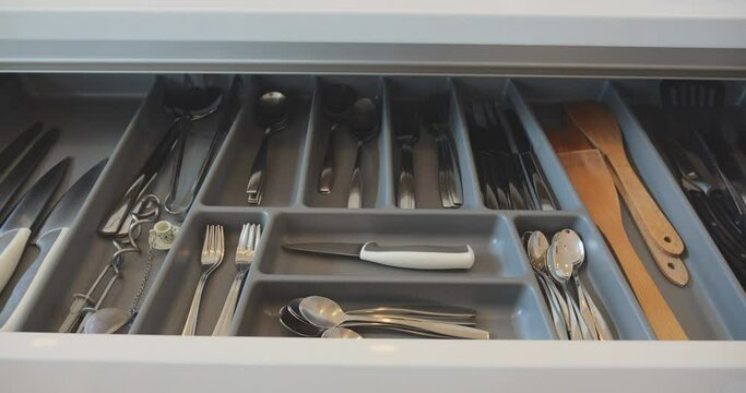 Different cutlery in kitchen drawer in domestic kitchen