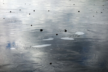 Air bubbles under the frozen ice surface of the lake