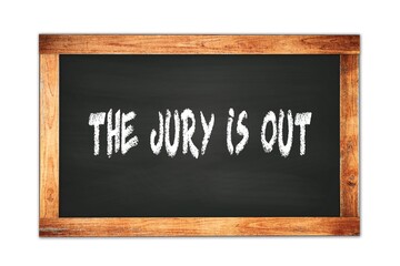 THE  JURY  IS  OUT text written on wooden frame school blackboard.