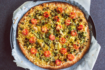 plant-based food, vegan flatbread pizza with cherry tomatoes and dairy-free cheese