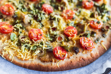 plant-based food, vegan flatbread pizza with cherry tomatoes and dairy-free cheese