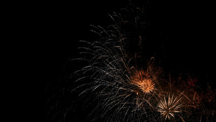 Small colourful festive fireworks above residential area, night cityscape