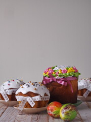 Home cooking.Kulichi is a traditional festive pastry for the Easter holiday, decorated with ribbons, on a light wooden background.
