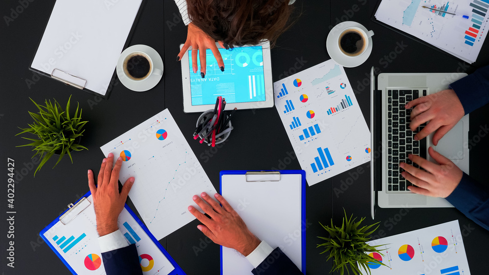 Poster top view of business people having meeting analysing financial statistics graphs planning next proje