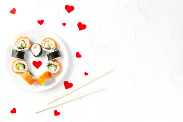 Sushi in the form of a heart on a white plate. Valentine's Day. Horizontal orientation, copy space.