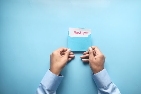 Man Hand Reading A Thank You Letter 