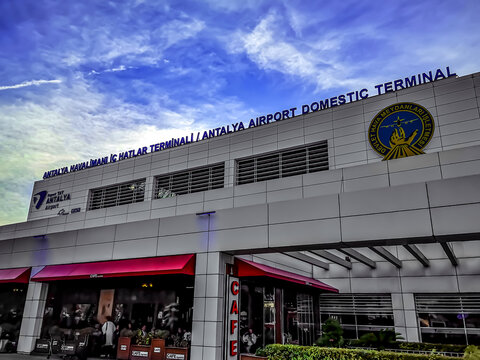 Turkey, Antalya - October 24, 2019: Modern building with signboard Antalya Airport Domestic Terminal. Building with the logo and the name of the airport in the evening - outside view