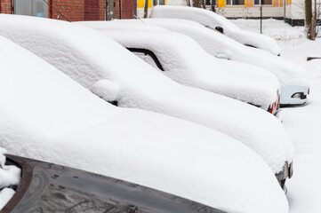 Cars covered with a thick layer of snow