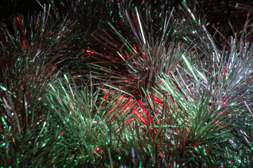 Christmas tinsel made of foil with green and red reflections