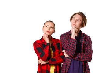 a guy and a girl in casual clothes, checkered shirts are standing and looking thoughtfully towards...