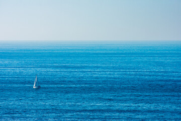 sailboat sailing in the middle of the ocean