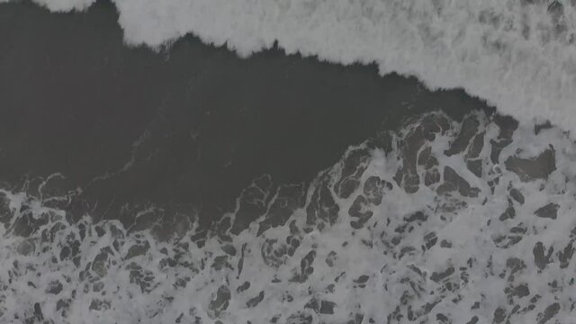 Slow Motion Of Foamy Waves Splashing In The Sea - birdseye view, top-down
