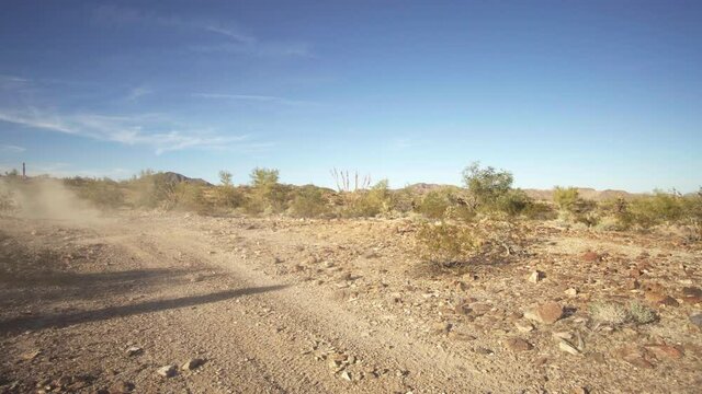 Side by side, Quad 4x4 atv passing at a dirt road at Quartzsite, AZ, USA.