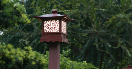 Wooden street lamp in the garden