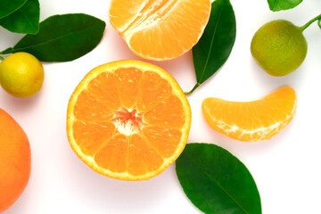 Tangerines or clementines with leaves on white background. Top view.