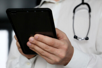 Man doctor with a tablet PC in hands. Work of medical staff	