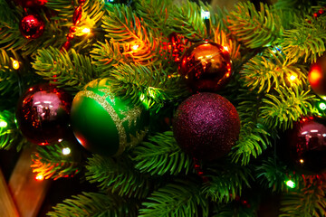 Christmas decorations on a decorated Christmas tree. Beautiful Christmas decorations