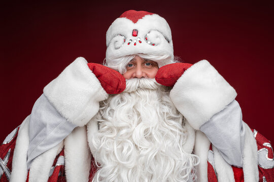 santa claus with long white beard and mustache, picture isolated on red background