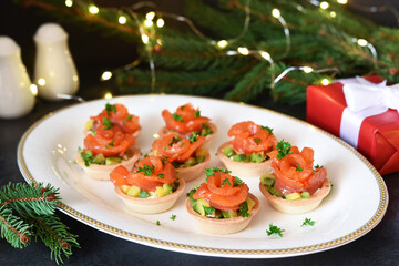 Snack with salmon and avocadon on New Year's table.