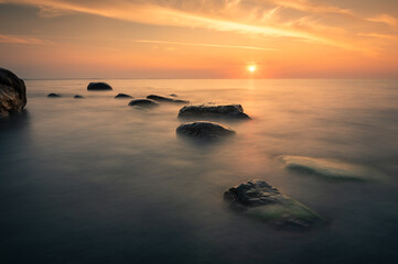 Beautiful stones on the Baltic Sea beach at the sunset