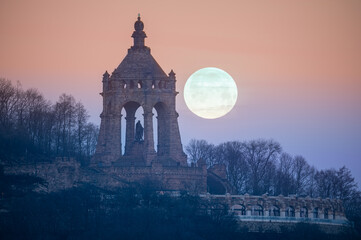 The moon setting behind the Kaiser Wilhelm Monument in Porta Westfalica