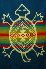 Colorful market with beautiful and unique handicraft fabric patterns available in Otavalo, Ecuador