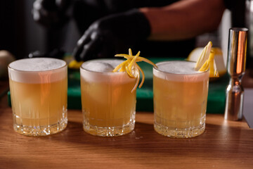 bartender preparing and decorating cocktails at the bar. profession concept